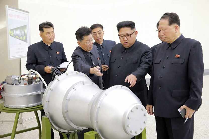  North Korean leader Kim Jong Un inspects metal casing.