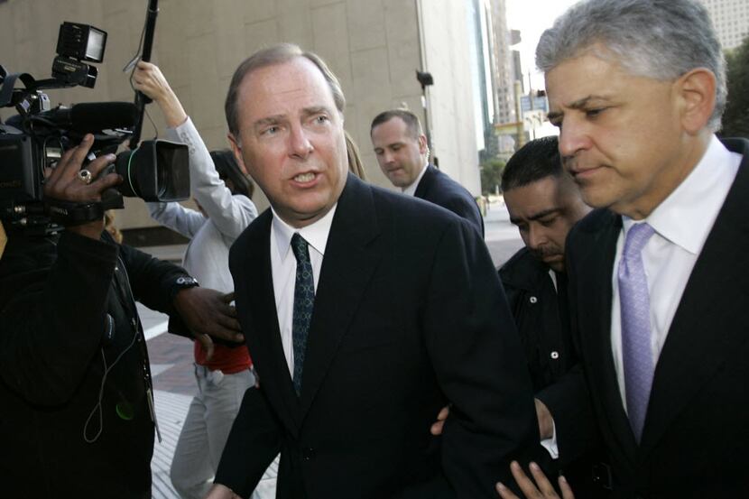 Former Enron CEO Jeff Skilling (left) leaves the federal courthouse in Houston in 2006 after...