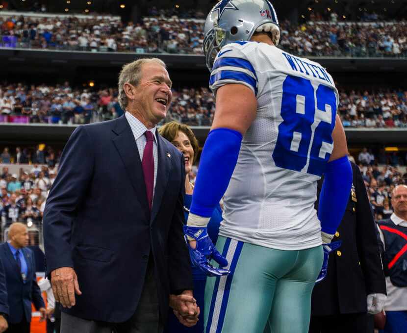 Former President George W. Bush and former First Lady Laura Bush greet Dallas Cowboys tight...