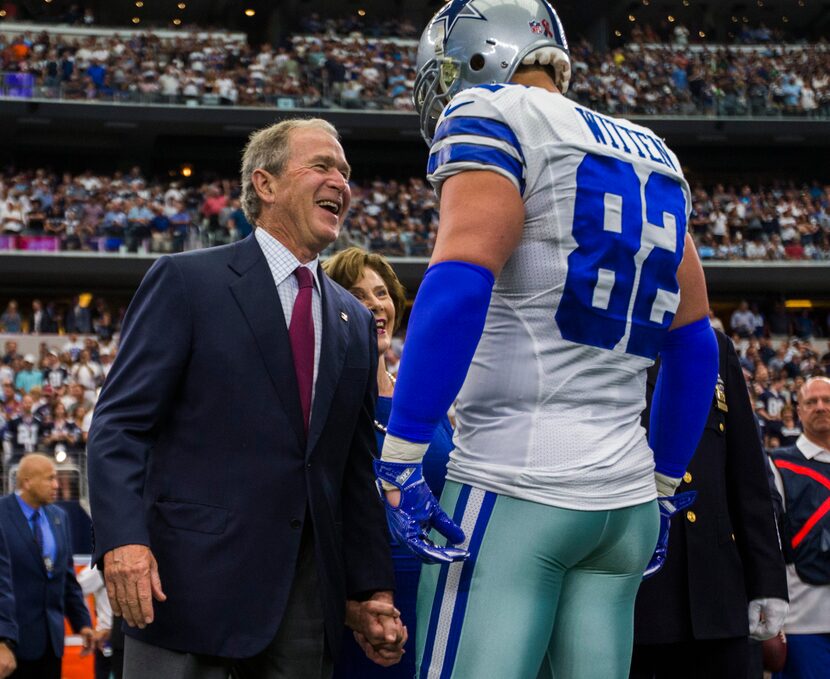 Former President George W. Bush and former First Lady Laura Bush greet Dallas Cowboys tight...