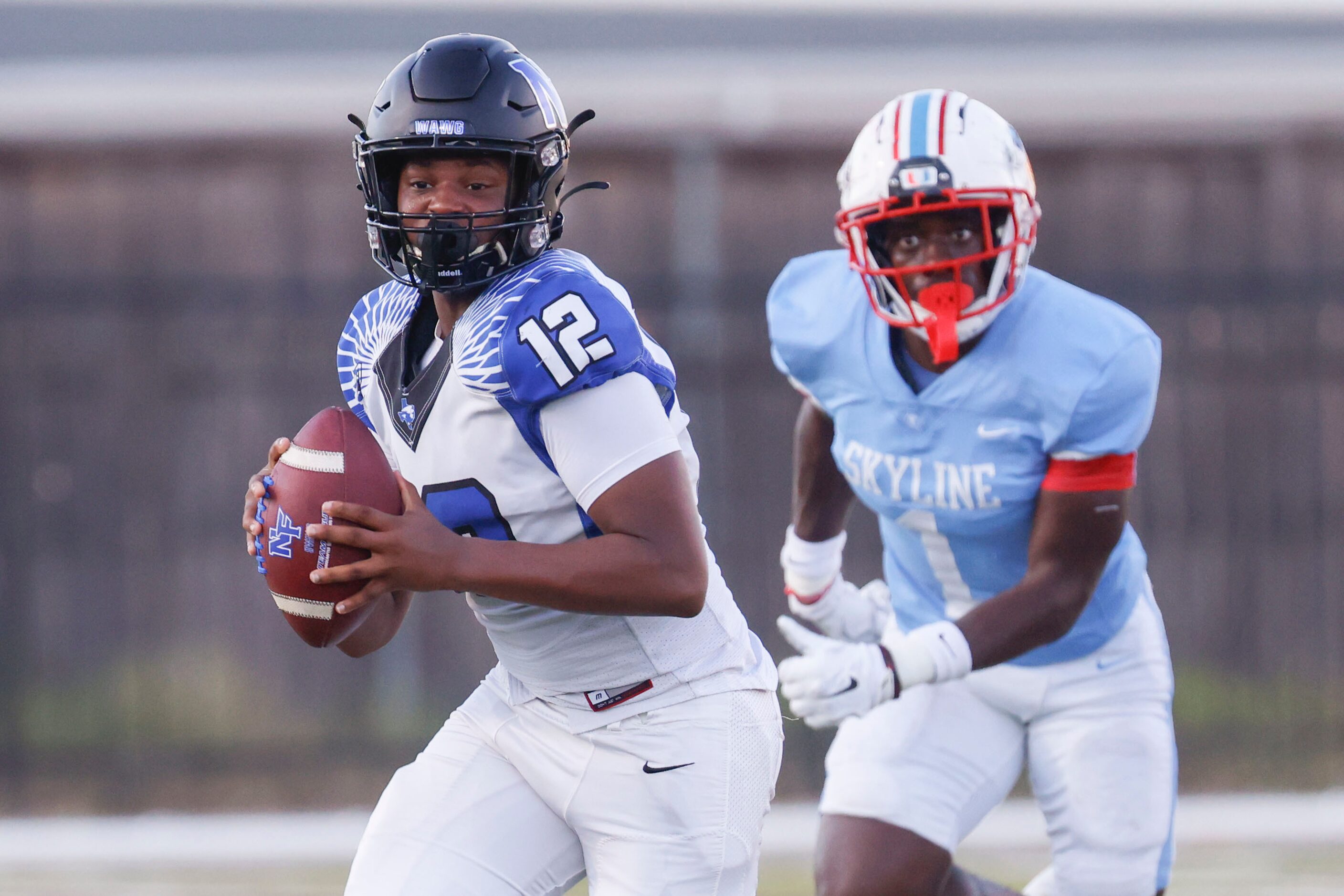 North Forney High’s Michael Douglas (12) looks to pass past Skyline High’s Adam Dweh (1)...