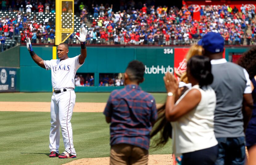 Texas Rangers Adrian Beltre (29) waves to the crowd as his family looks on after hitting his...