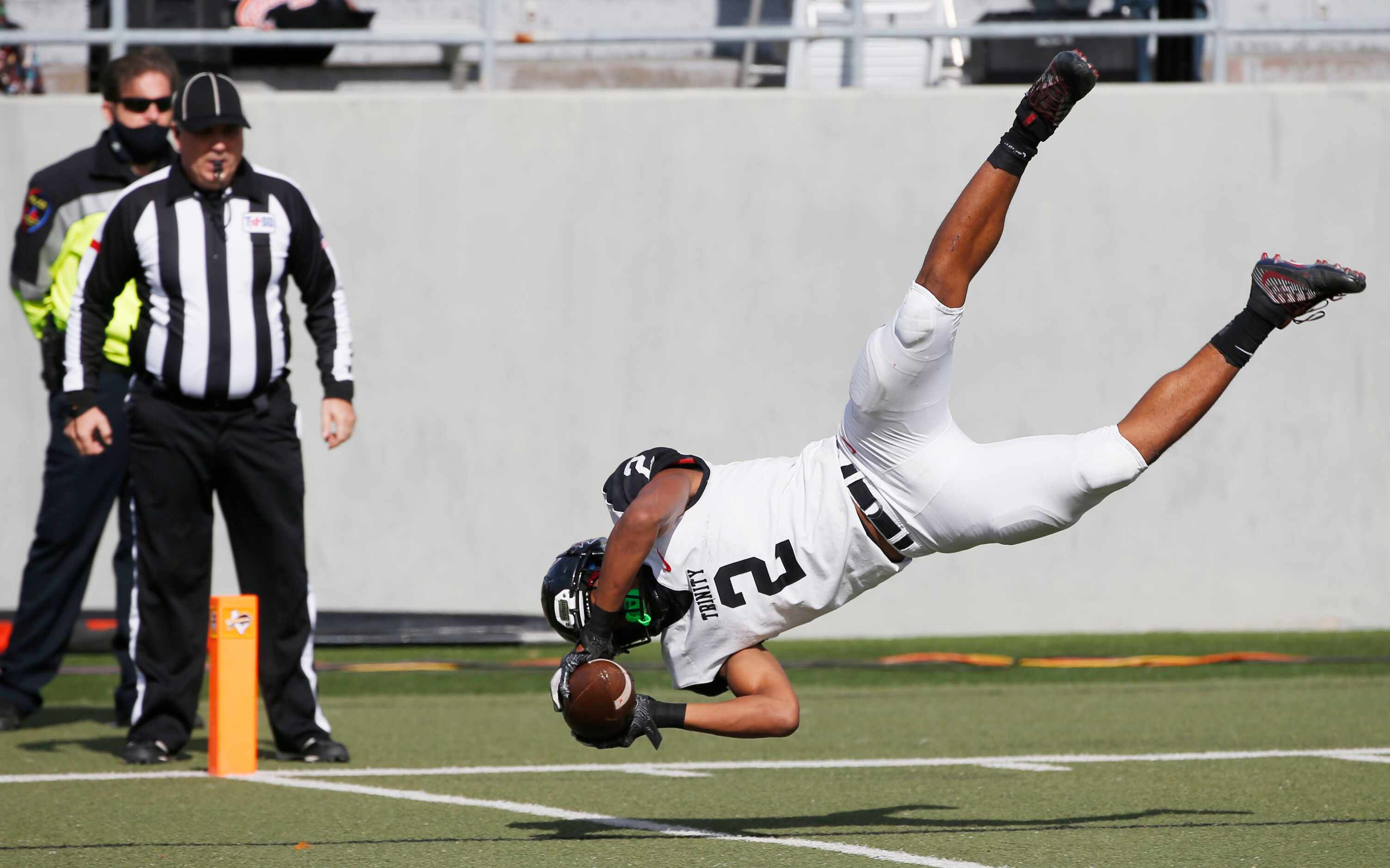 Euless Trinity running back Ollie Gordon (2) dives into the end zone for a rushing touchdown...