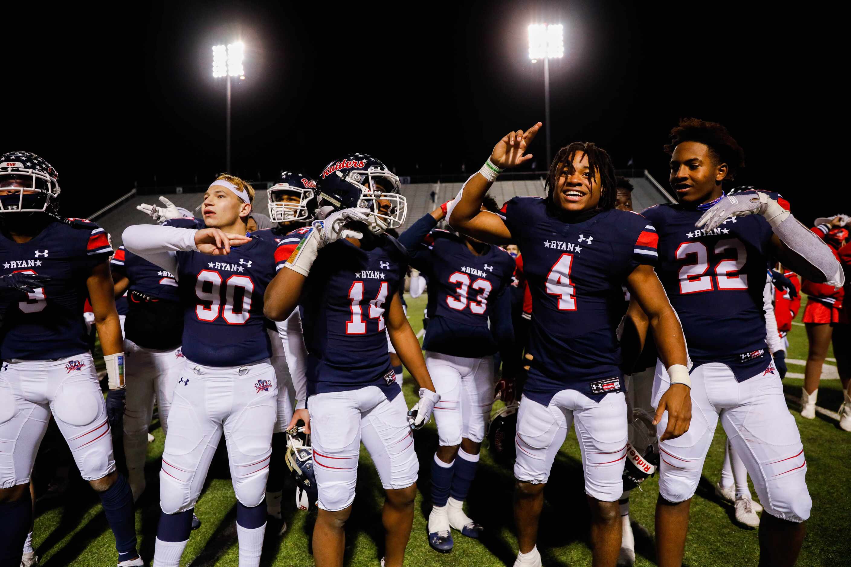 Denton Ryan football players celebrate winning the District 5-5A Division I title against...
