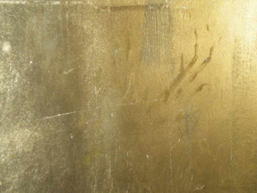 Ghostly fingerprints appear on the gold-leaf-covered walls at Muriel's Restaurant in Jackson...