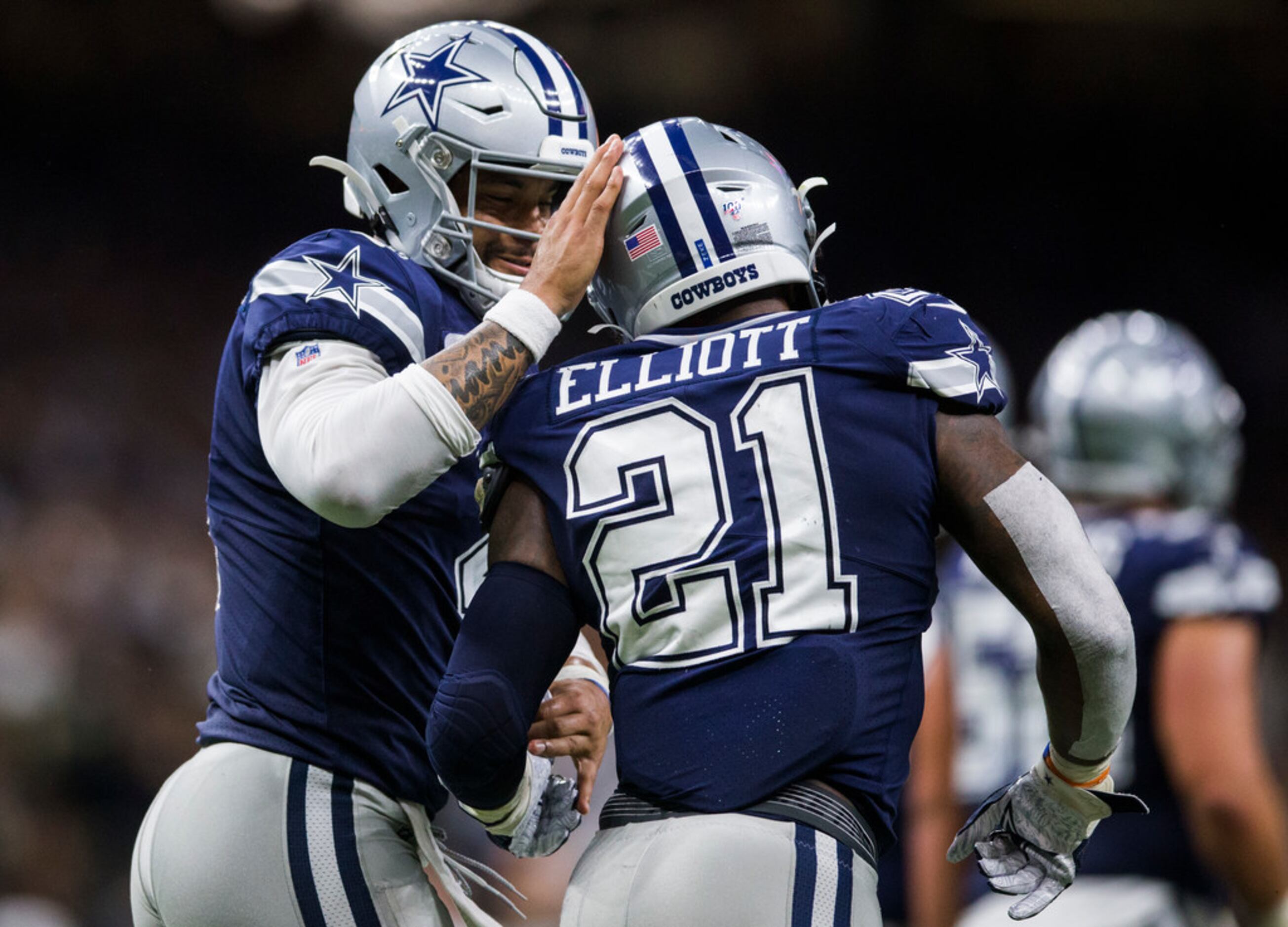 Dallas Cowboys quarterback Dak Prescott (4) celebrates a touchdown with running back Ezekiel...