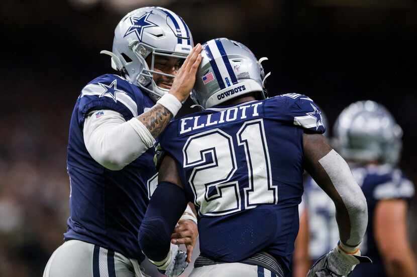 FILE - Cowboys quarterback Dak Prescott (4) celebrates a touchdown with running back Ezekiel...