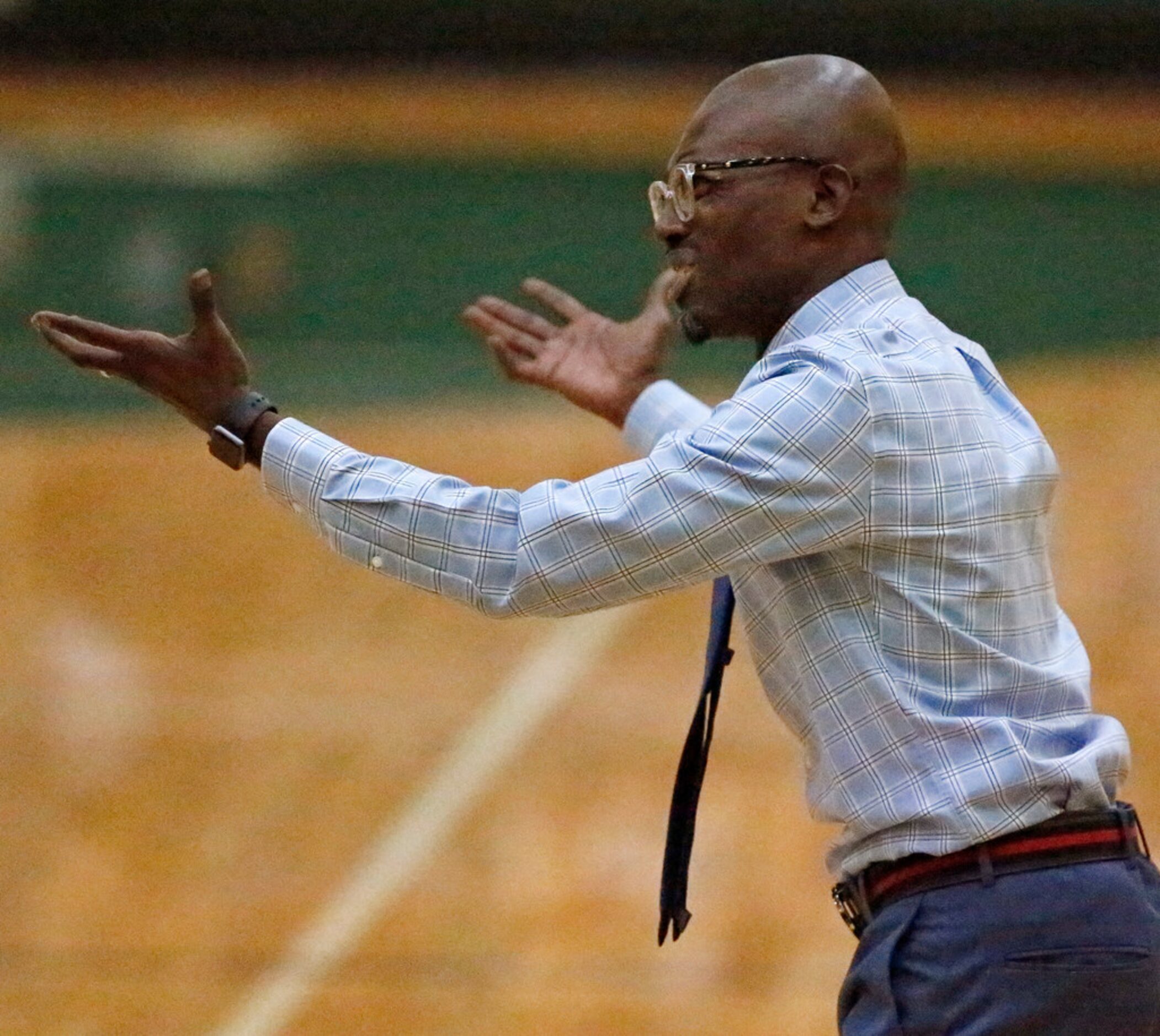 Madison High School head coach Damien Mobley questions a call during the first half as...