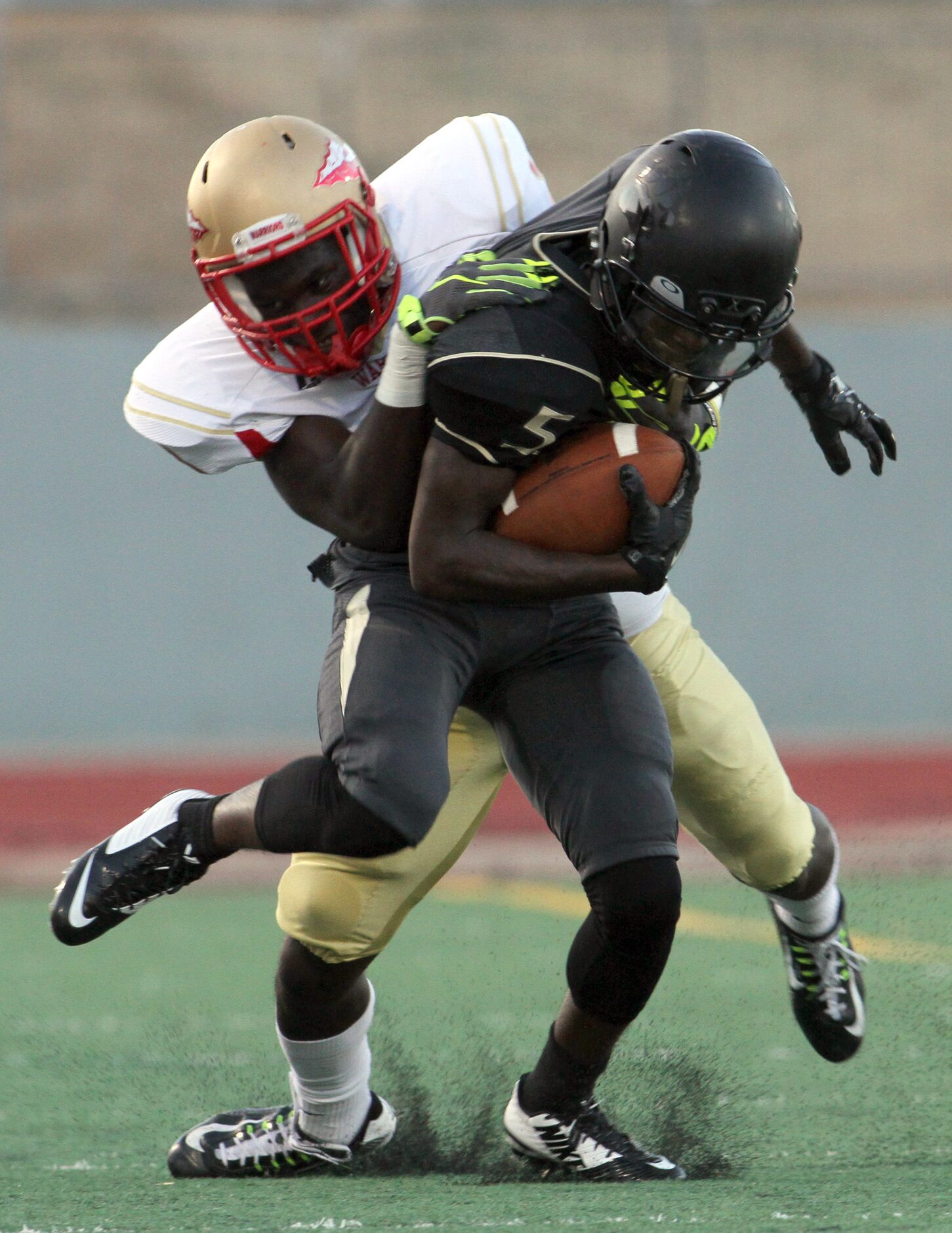 South Oak Cliff receiver MarKiese King (5) is wrestled down by South Grand Prairie safety...