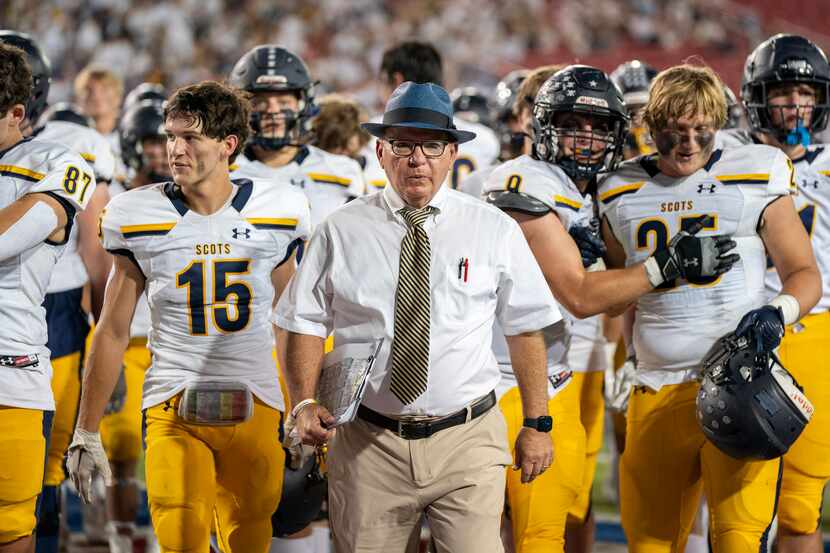 Highland Park head coach Randy Allen leads his team off the field during halftime of a high...