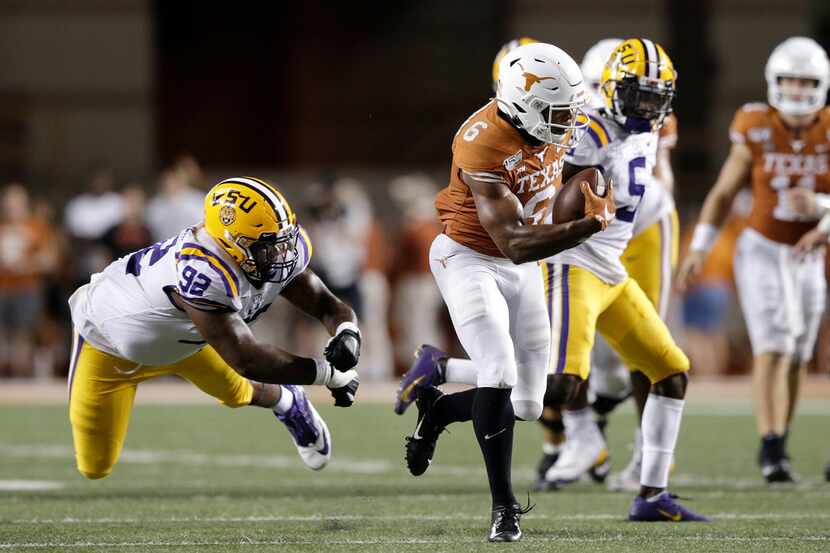AUSTIN, TX - SEPTEMBER 07:  Devin Duvernay #6 of the Texas Longhorns breaks the tackle by...