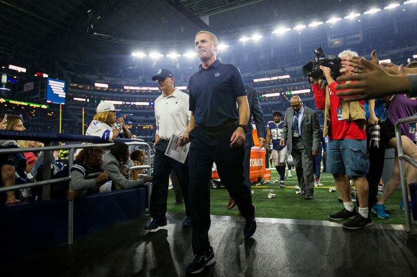 Dallas Cowboys head coach Jason Garrett walks off the field after a 28-6 loss at an NFL game...