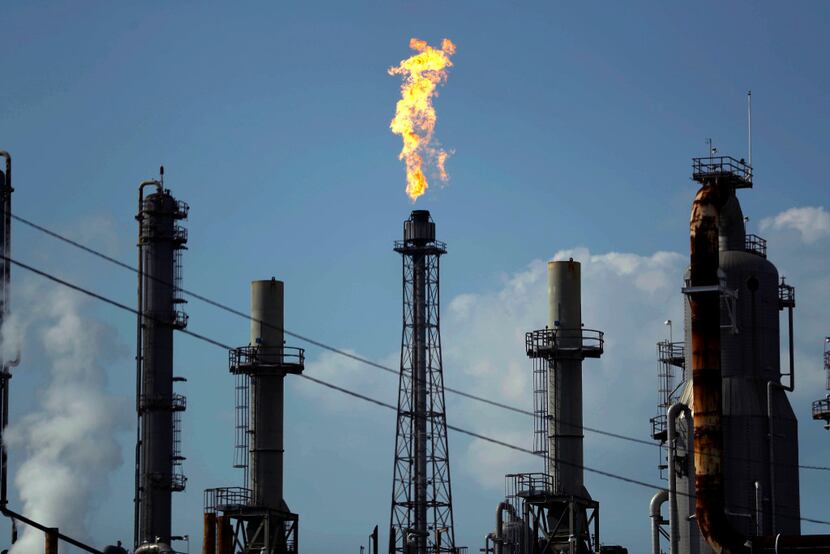 A flame burns at the Shell Deer Park oil refinery on Aug. 31 in Deer Park, Texas. While it's...