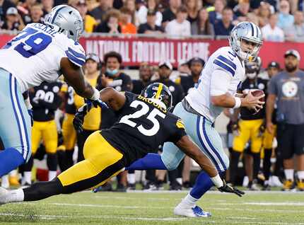 Dallas Cowboys quarterback Garrett Gilbert (3) rolls out against Pittsburgh Steelers safety...