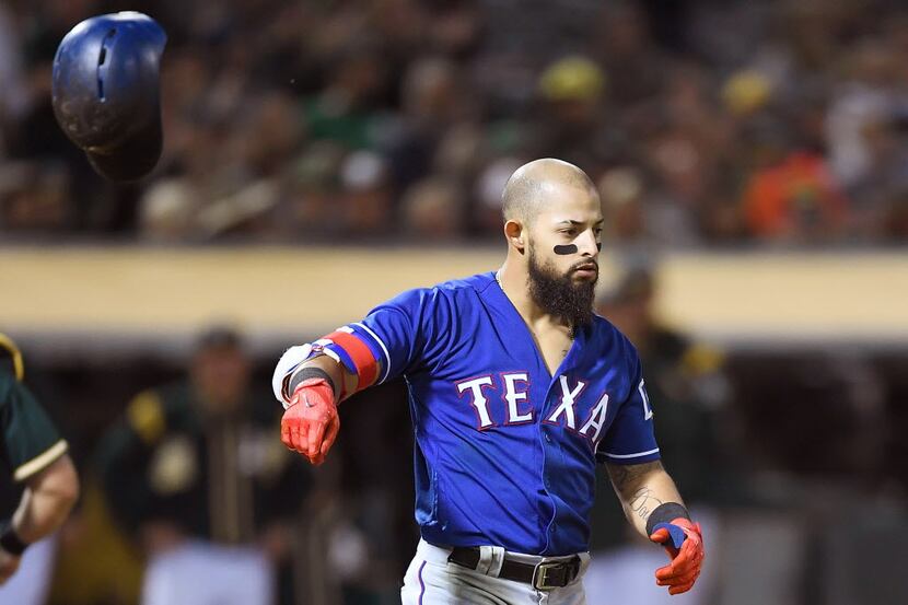 OAKLAND, CA - SEPTEMBER 22:  Rougned Odor #12 of the Texas Rangers reacts by tossing his...