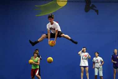 Mark Paterson, 15, of Trinity Christian Academy, dodges a ball while looking at others to...