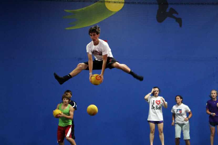 Mark Paterson, 15, of Trinity Christian Academy, dodges a ball while looking at others to...