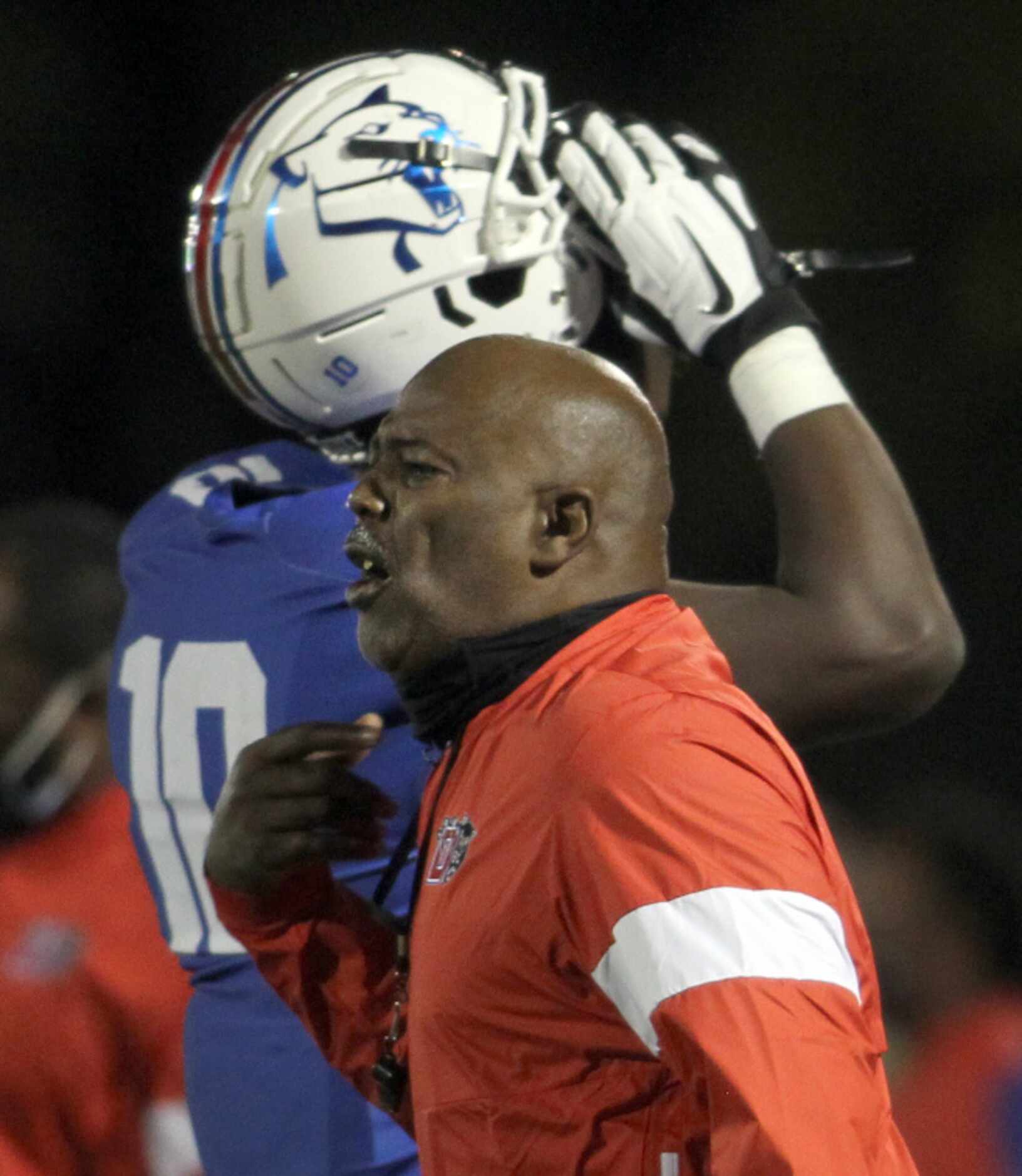 Duncanville head coach Reginald Samples directs his players from the team bench area during...