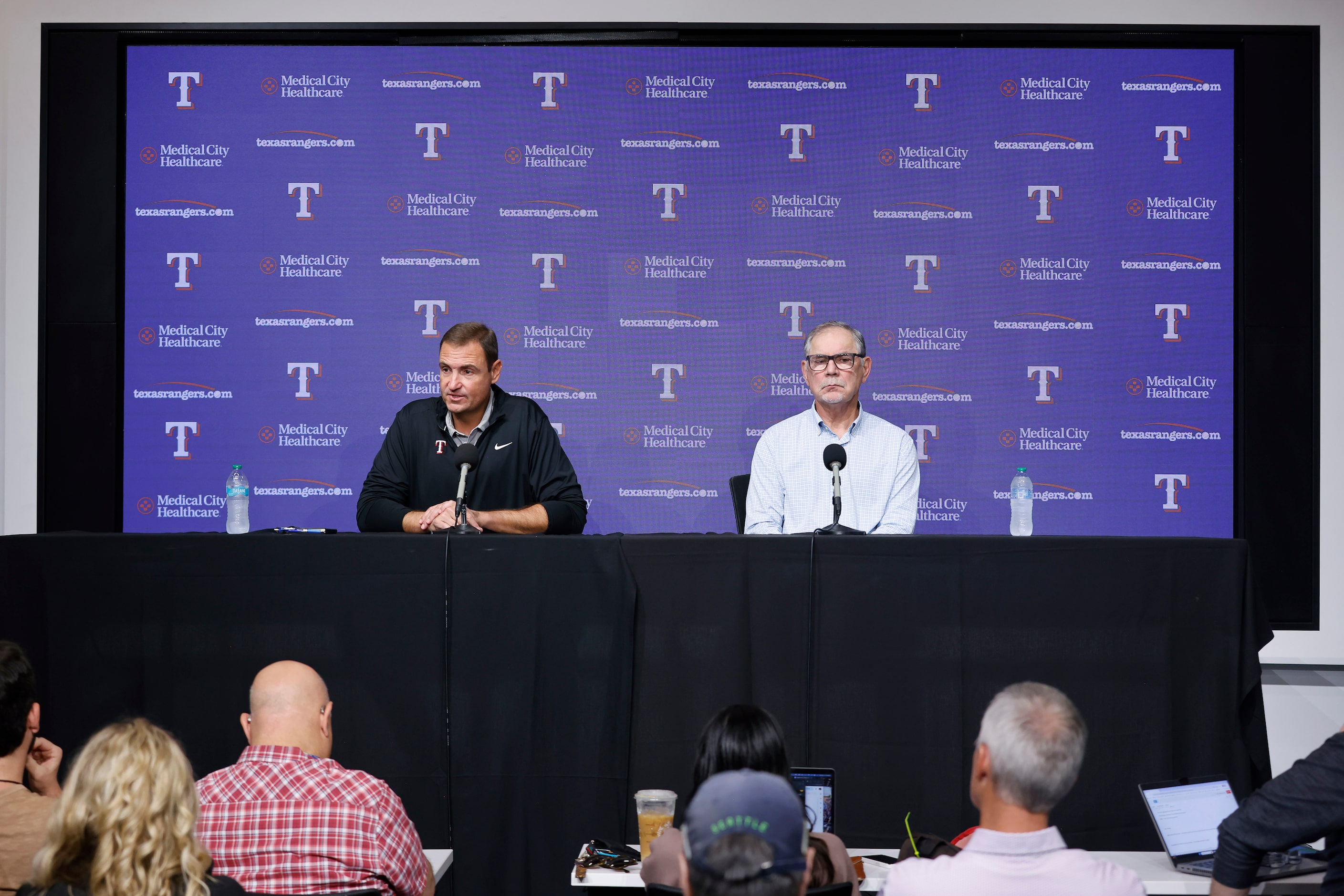 Texas Rangers general manager Chris Young (left) and manager Bruce Bochy respond to...