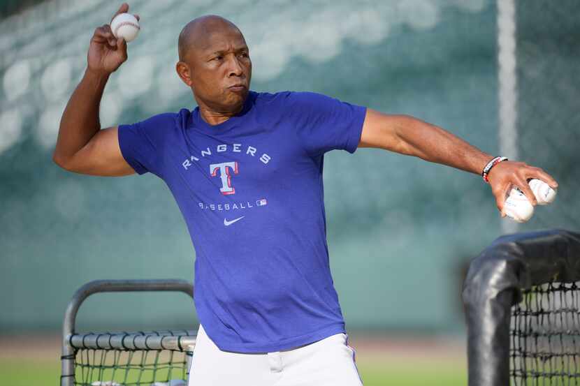 Texas Rangers interim manager Tony Beasley throws batting practice before a baseball game...