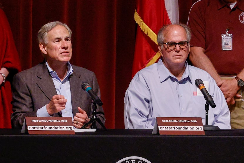 Gov. Greg Abbott, left, speaks alongside Uvalde Mayor Don McLaughlin Jr. during a news...