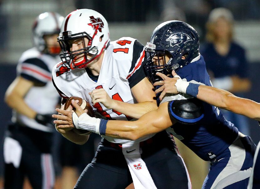 Flower Mound linebacker Connor Lee (44) sacks Flower Mound Marcus quarterback Michael Henry...