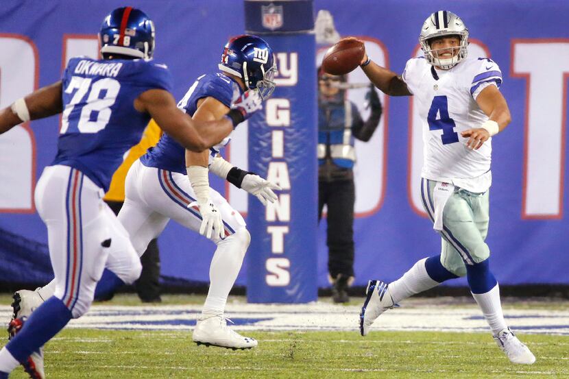 Dallas Cowboys quarterback Dak Prescott (4) looks to pass under pressure from New York...