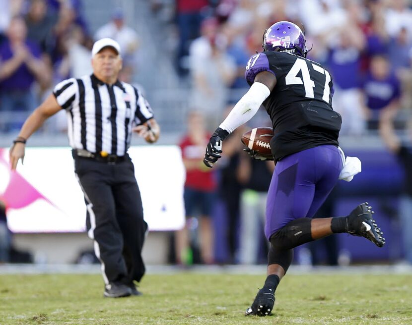 TCU Horned Frogs linebacker Paul Dawson (47) returns a fourth quarter interception for a...