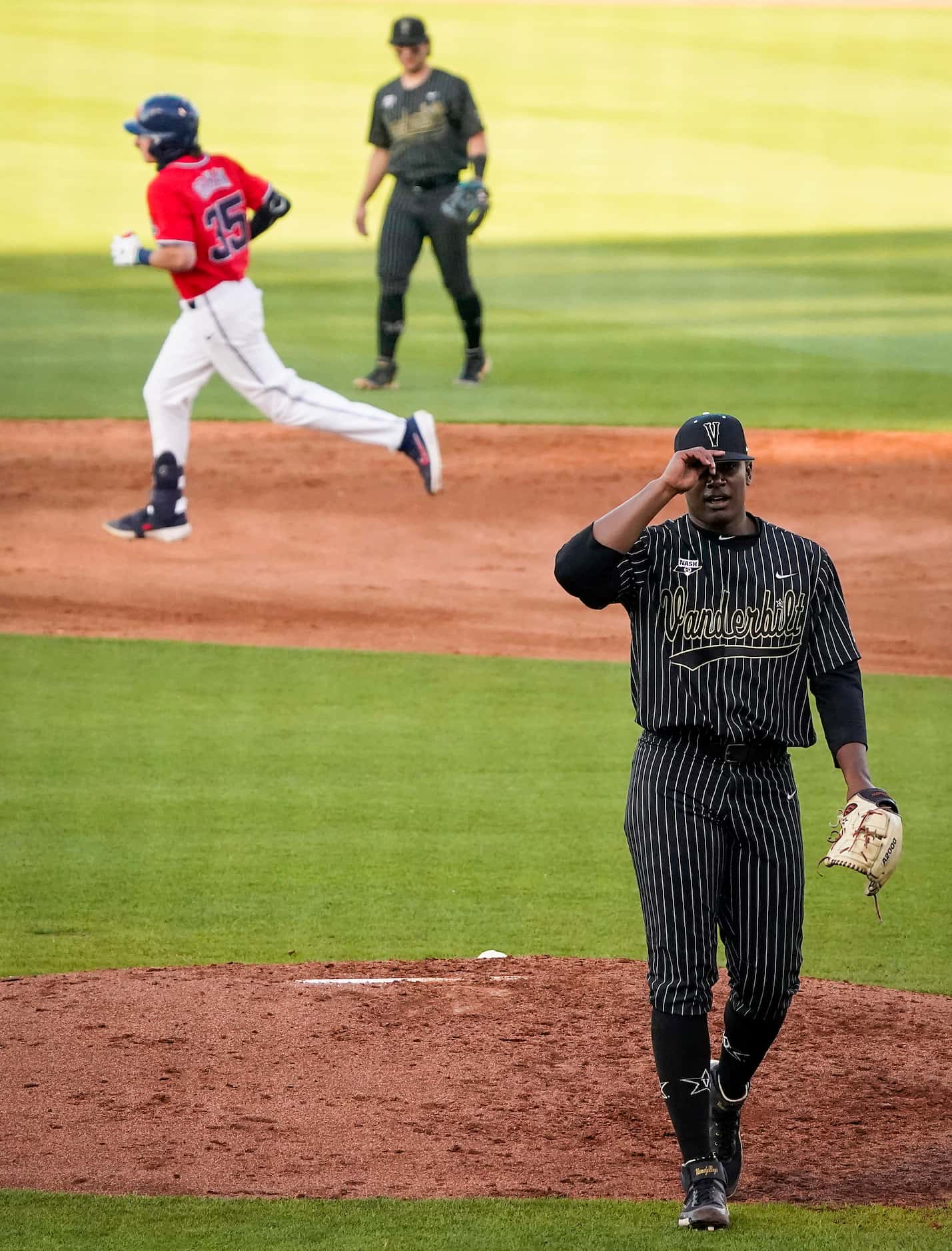 Vanderbilt pitcher Kumar Rocker reacts after a home run by Vanderbilt pitcher Chris McElvain...