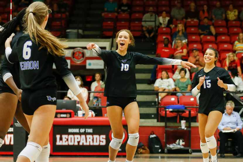 Hebron setter Harmony Sample (10) celebrates with teammates after a point during a...