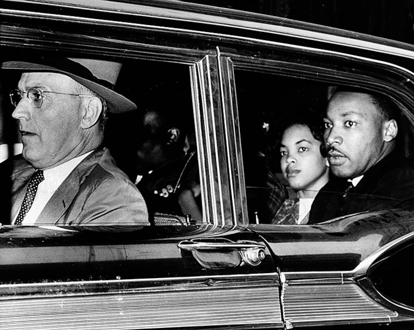  Dr. Martin Luther King Jr., right, looks out the window of a police car as he and other...