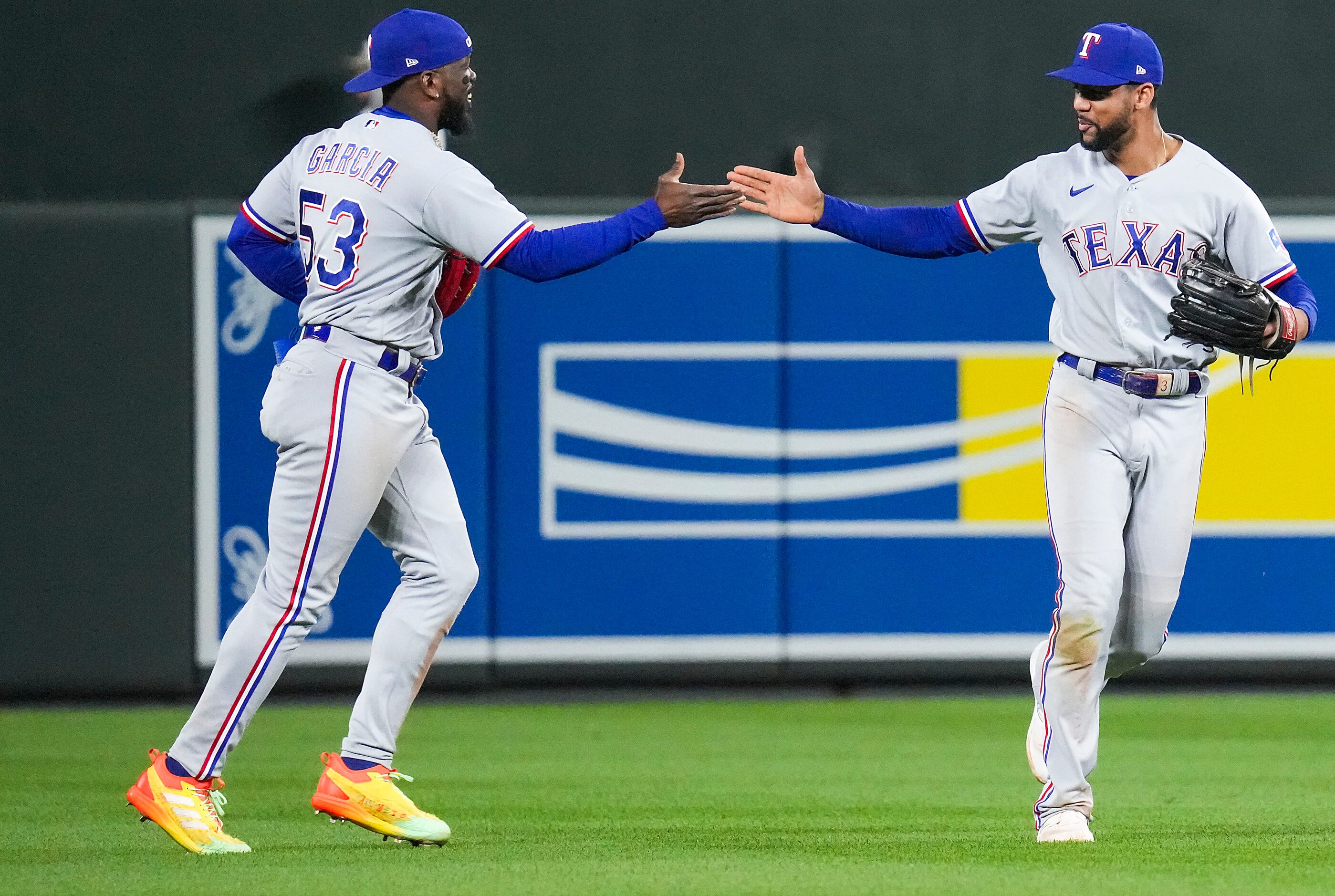 Texas Rangers center fielder Leody Taveras celebrates with right fielder Adolis Garcia after...