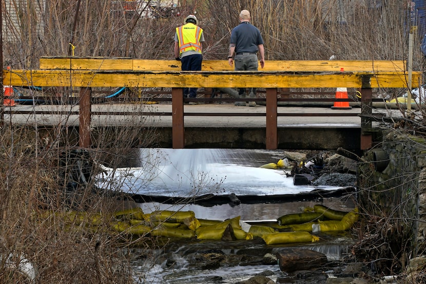 HEPACO workers, an environmental and emergency services company, observe a stream in East...