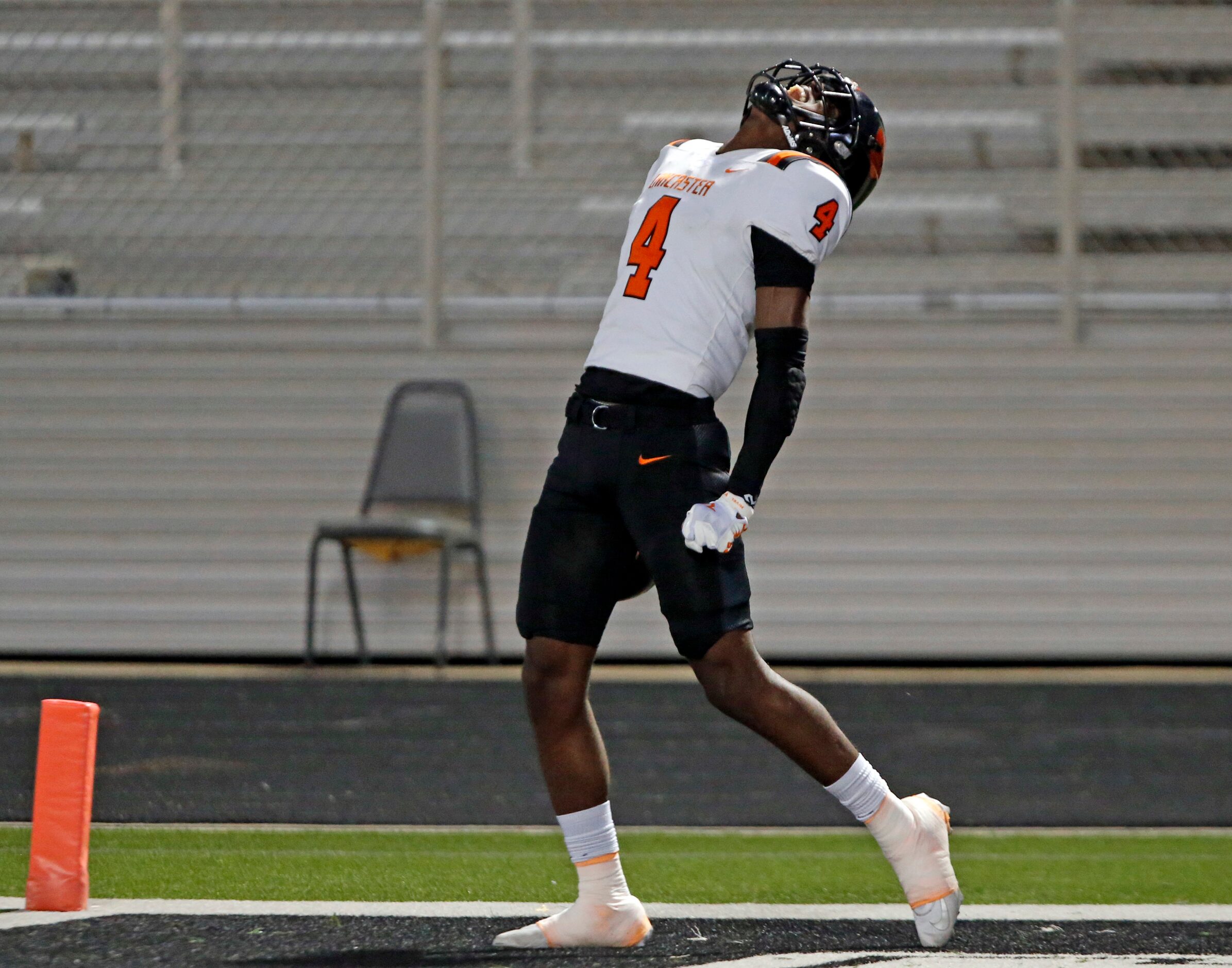 Lancaster high’s Emmanuel Choice (4) yells after making a touchdown catch during the first...