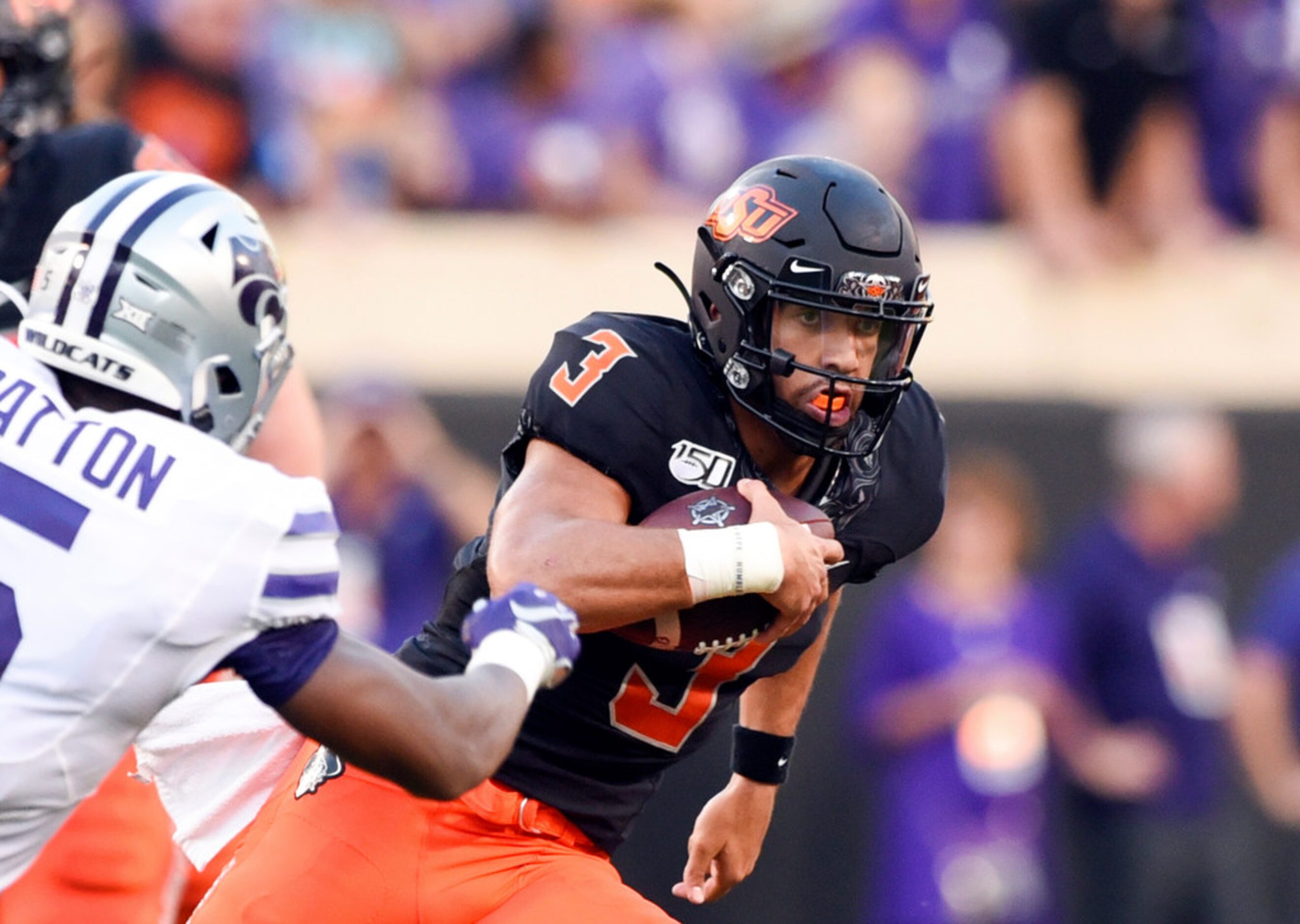 Kansas State linebacker Da'Quan Patton, left, reaches for Oklahoma State quarterback Spencer...