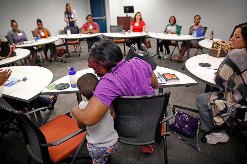 
Antranette Canady hugs her 5-year-old grandson, Kwamane Dale, during a Women's Independence...
