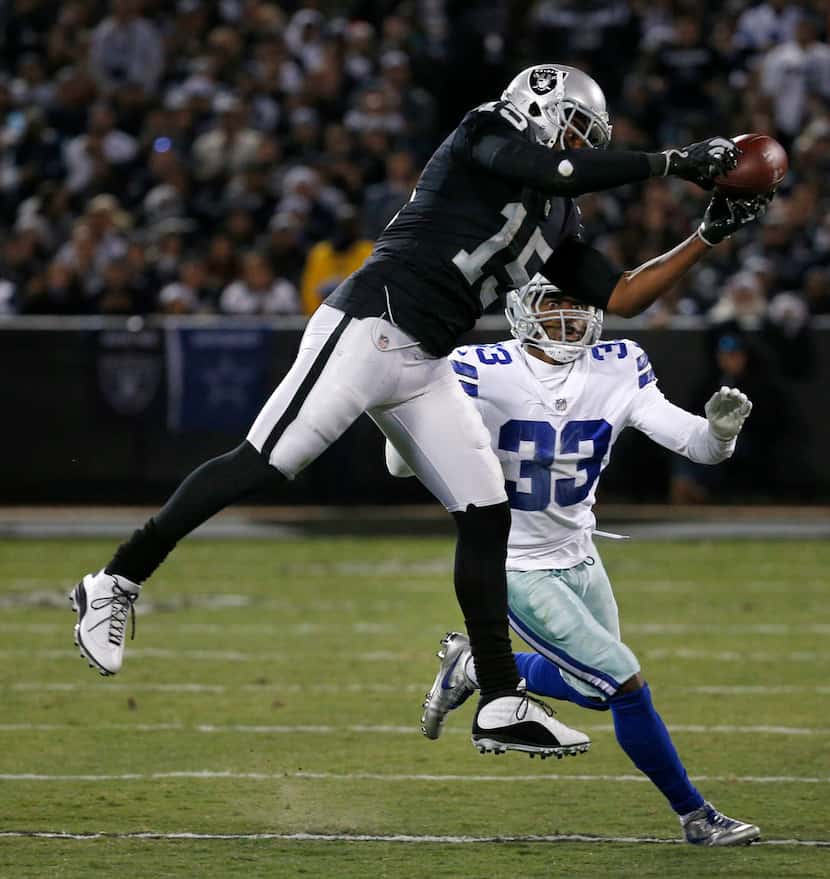 Oakland Raiders wide receiver Michael Crabtree (15) makes a catch against Dallas Cowboys...