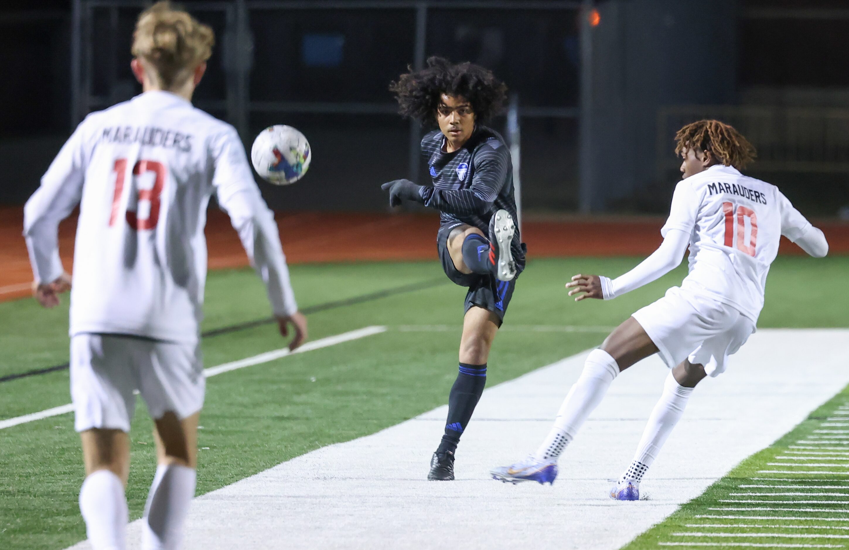 Hebron’s Alejandro Appio-Riley (21) kicks the ball past Flower Mound Marcus’ Aaron Pondeca...