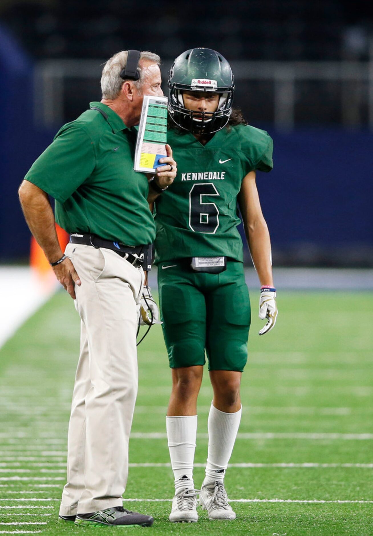 Kennedale's head coach Richard Barrett talks with Ali Latifi (6) in a game against...