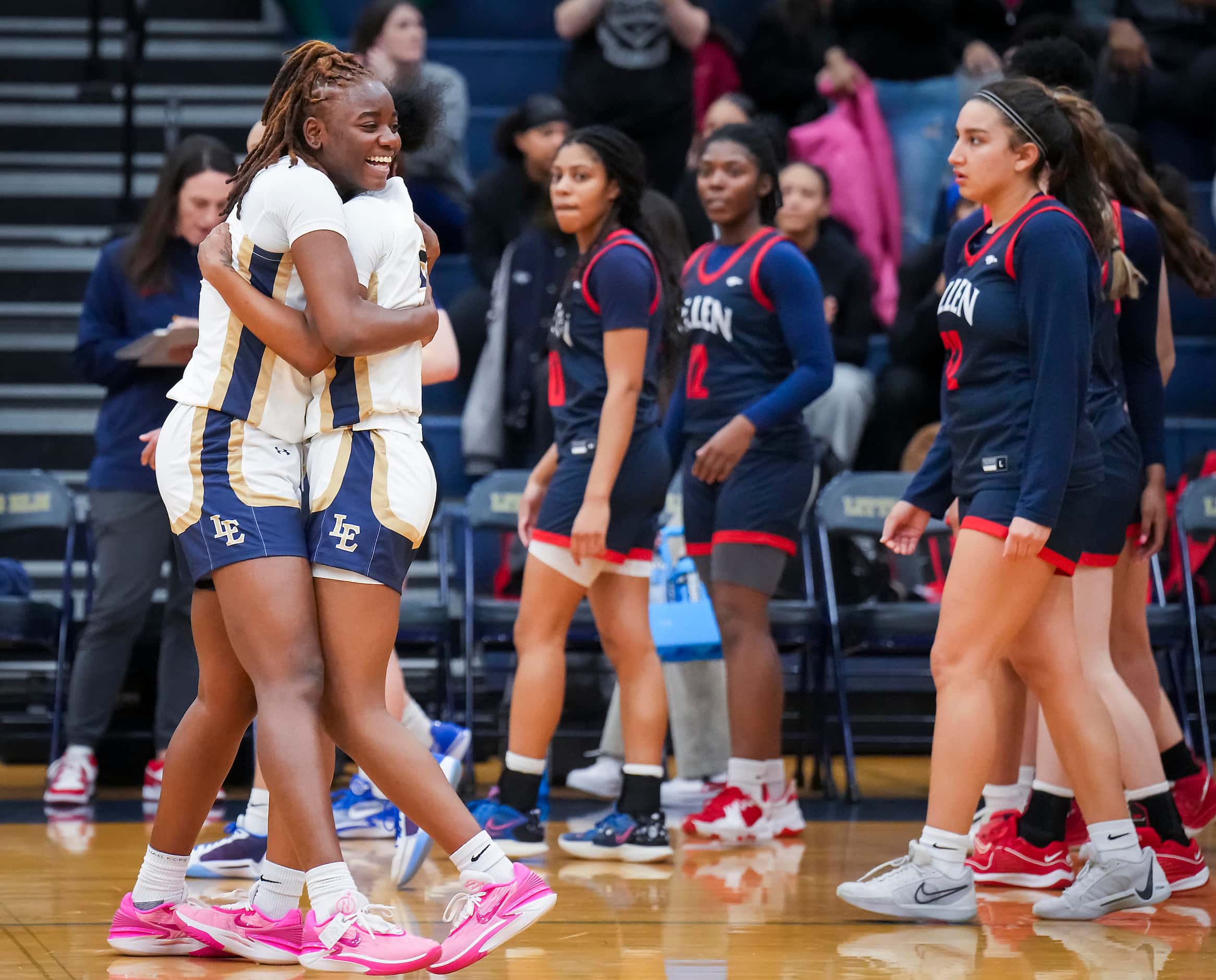 Little Elm's Kam Williams (left) hugs Madison Martin as they celebrate after a victory over...