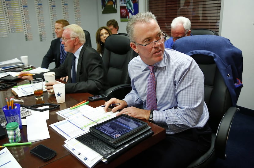 Dallas Cowboys executive vice president Stephen Jones studies the draft picks leading up to...