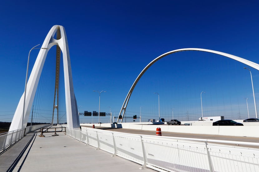 Cables and arches rise over the pedestrian and bike lane of the Margaret McDermott Bridge,...