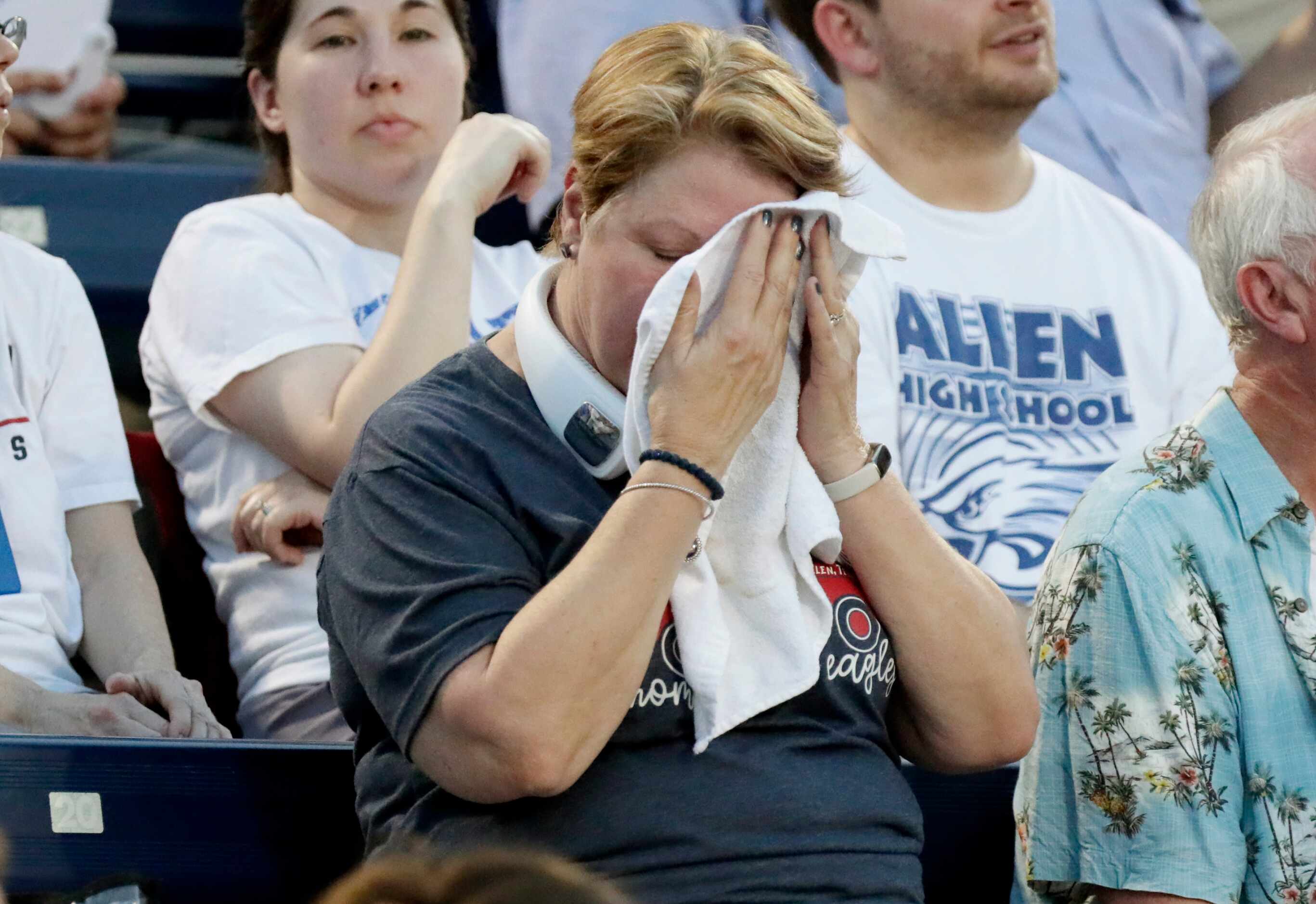 An Allen High School supporter attempts to deal with the heat during the first half as Allen...
