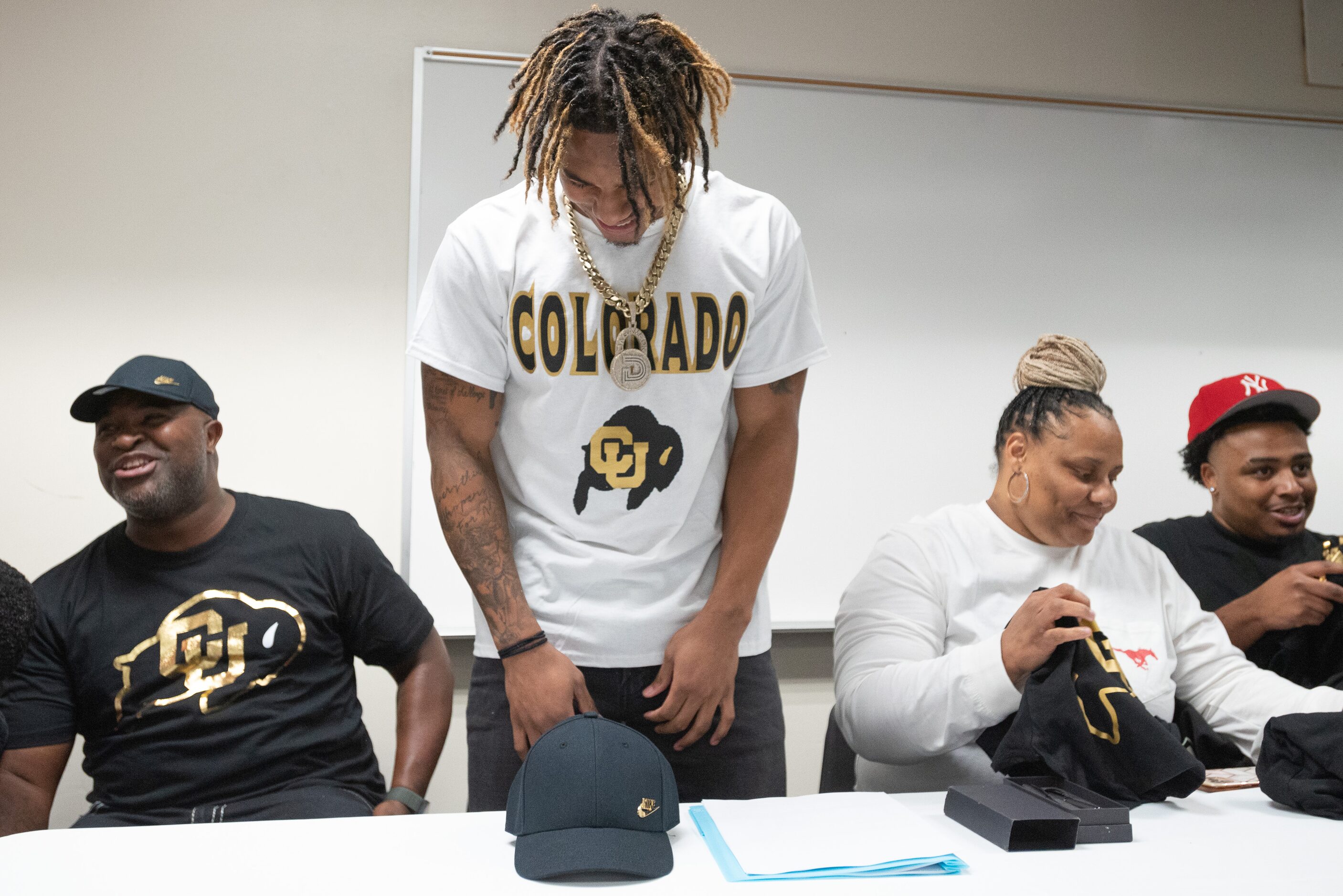 DeSoto high school football player Jaden Milliner-Jones shows off his Colorado merchandise...