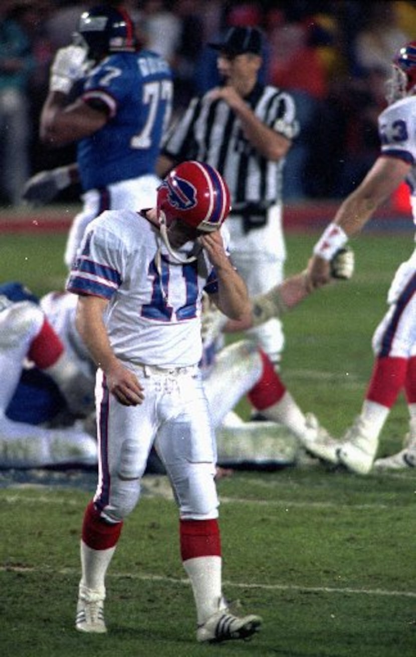 Scott Norwood of the Buffalo Bills walks dejectedly off the field after missing what would...