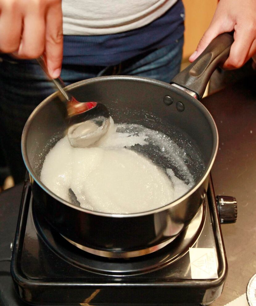 
Eighth grader Jimena Torres stirs a pot of boiling water and sugar.
