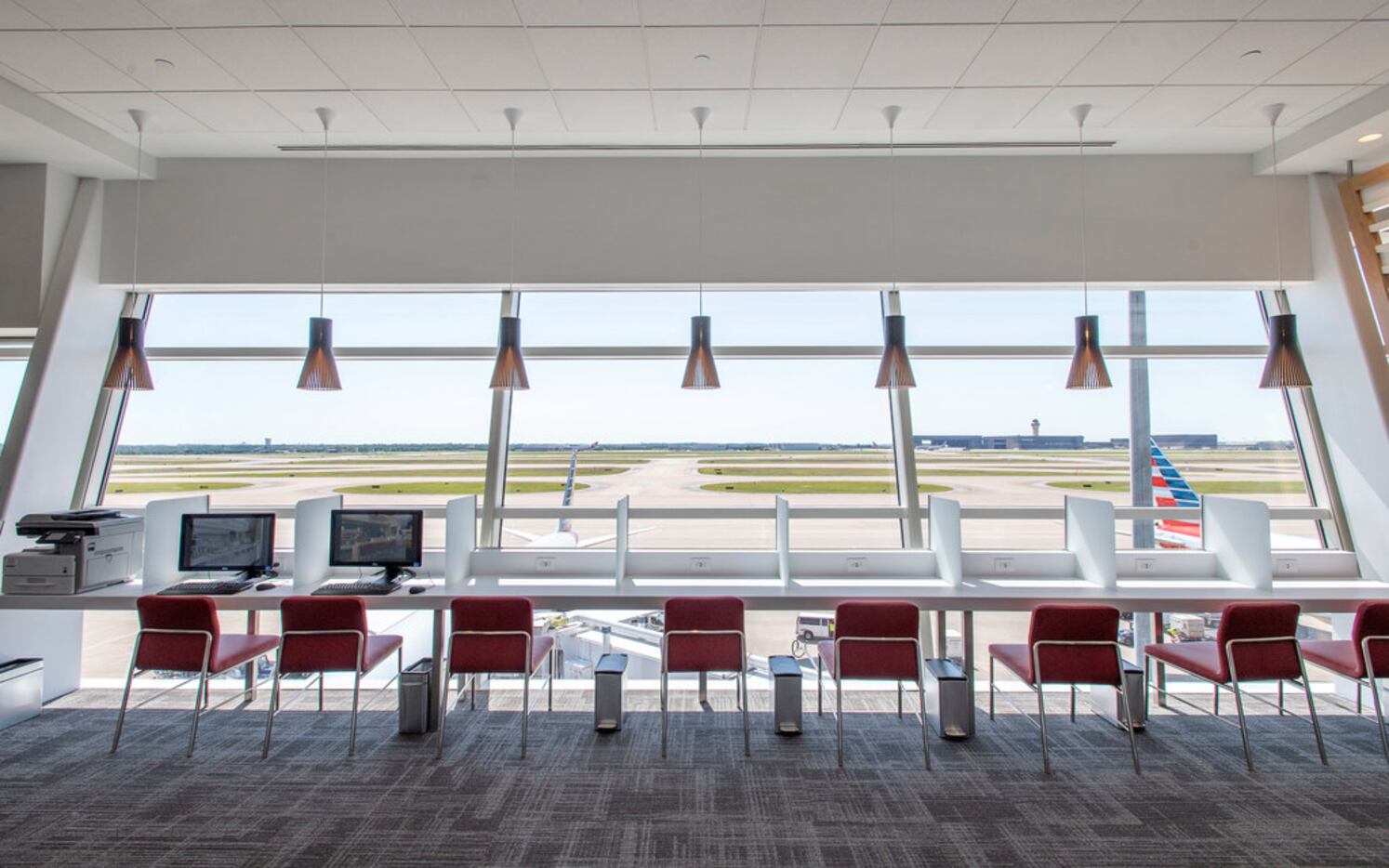 A business seating area overlooks the tarmac in the new American Airlines Flagship Lounge on...