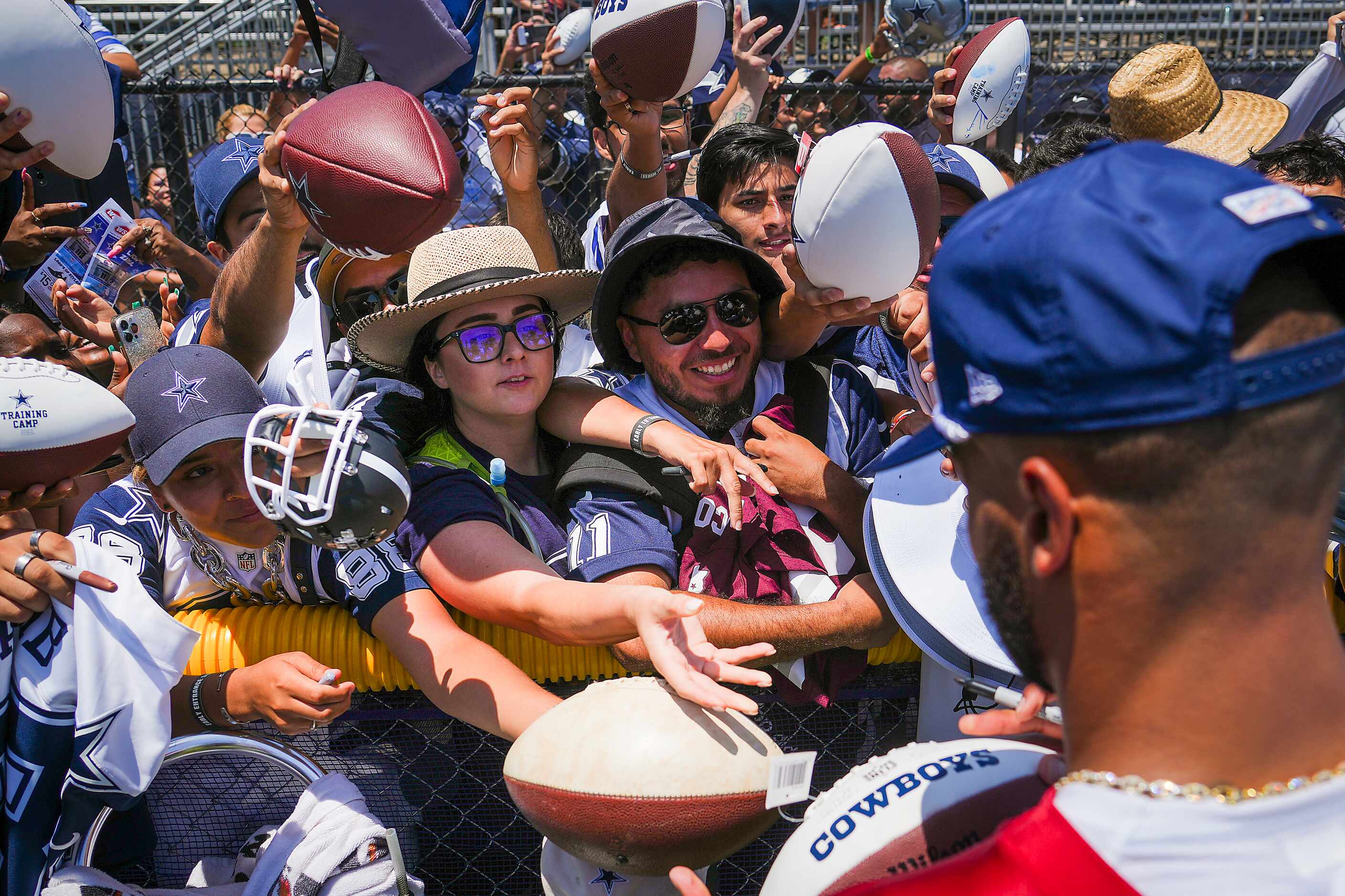 Dallas Cowboys quarterback Dak Prescott  signs autographs for fans following a training camp...