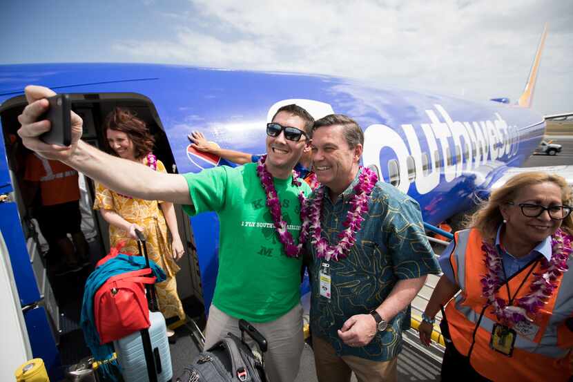 Southwest Airlines president Tom Nealon (second from right) greeted arriving passengers...