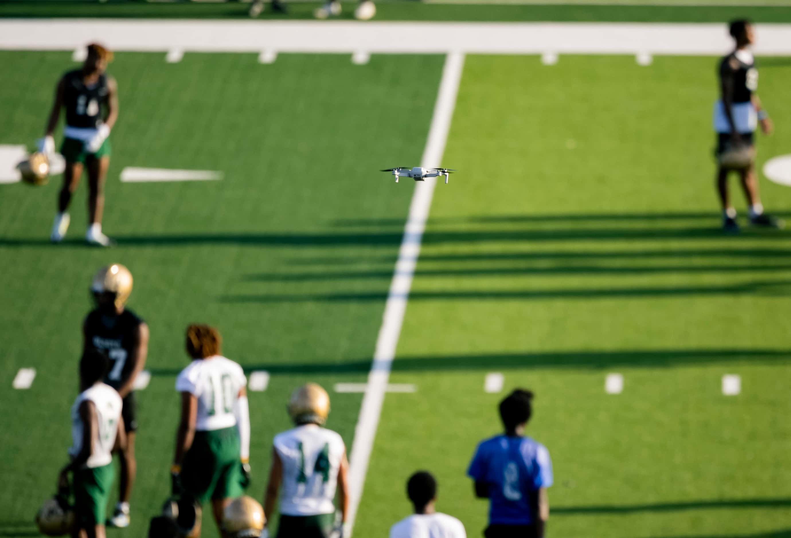 A drone records as DeSoto football players run drills during the first practice of the...